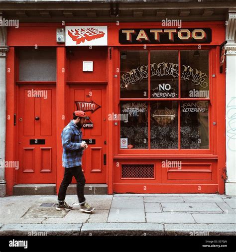 Man Walking By Tattoo Shop East London England Stock Photo Alamy