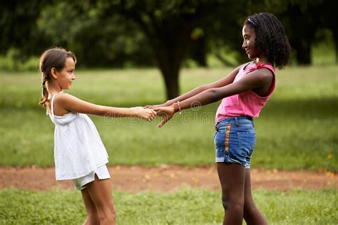 Children Playing Ring Around The Rosie In Park Stock Photo Image