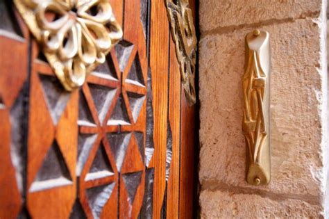 Hanging a mezuzah in front of a house or room invokes the responsibility to obey god and tells the world you live by his law. The Importance of Mezuzah Scroll in Jewish Communities ...