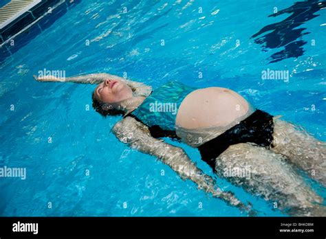 Pregnant Woman Swim Swimming Swims In A Swimming Pool Uk Stock