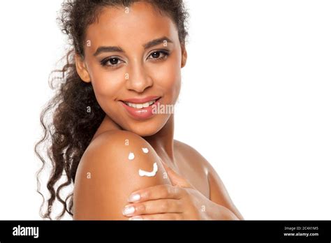 Beautiful Dark Skinned Woman With Body Lotion On Her Shoulder On White