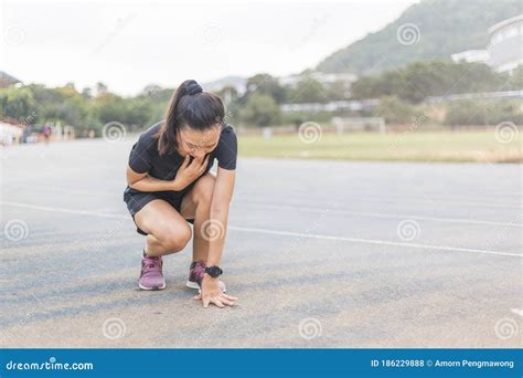 Women Are Tired After Running The Running Track She Is Touching On The