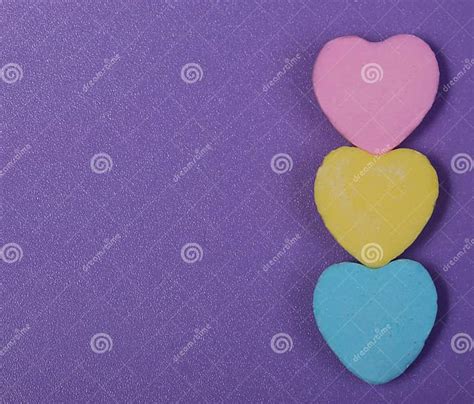 Colorful Hearts Three Sweetheart Candy Over Purple Background Stock