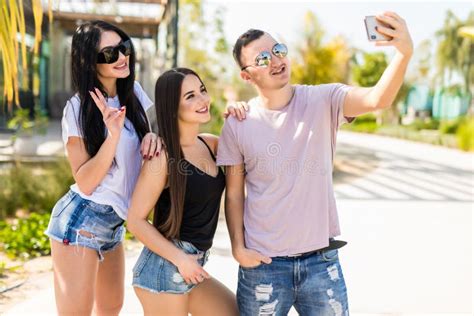 Three Young Women Having Fun And Taking Selfie Enjoying A Day Outdoors Stock Image Image Of