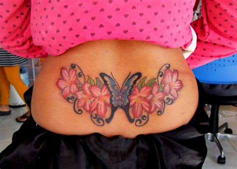 Lower back butterfly tattoo with flowers 2 | Girl back tattoos, Back tattoo, Back tattoos