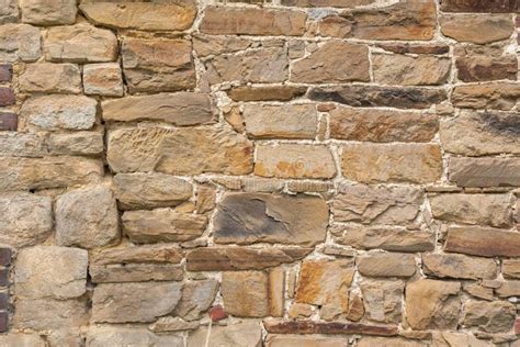 Texture Of Rough Masonry Yellow Rough Bricks And Cement Between Them