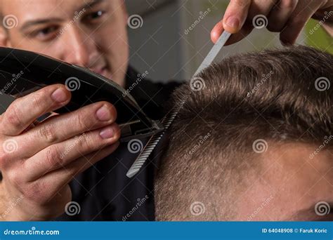 Hairdresser Cutting Clients Hair With An Electric Hair Clipper Stock