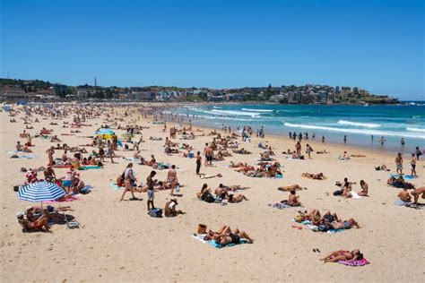 People Enjoying Hot Sunny Summer Day On Bondi Beach In Sydney Nsw