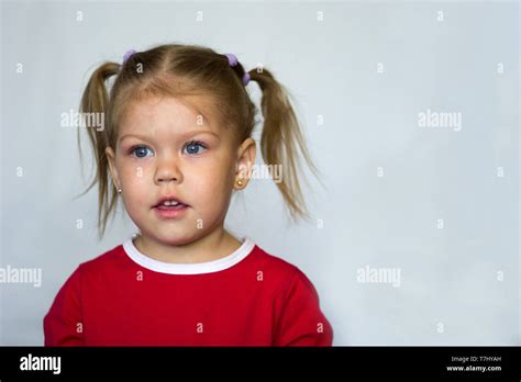 Portrait Of Little Girl With Blue Eyes Looking Aside On The White