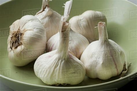 Whole Garlic Bulbs On A Shallow Bowl Stock Photo Dissolve