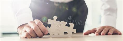Wide View Image Of A Businessman Holding Two Puzzle Pieces Match Stock