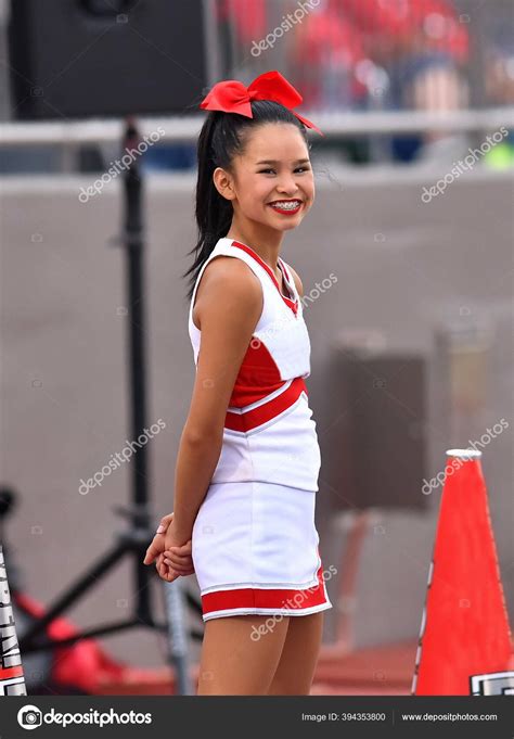 cute asian american cheerleader performing high school football game stock editorial photo