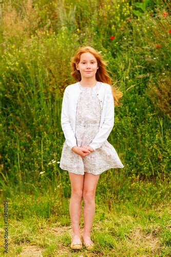 Outdoor Portrait Of A Cute Little Girl Of 8 9 Years Old With Long Red