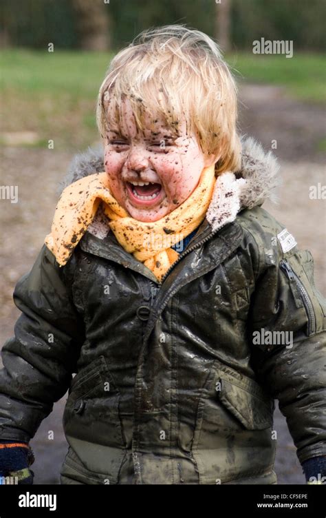 A Male Child With Mud Splattered Over His Face Stock Photo Alamy