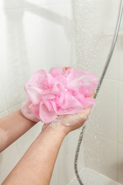 Premium Photo Closeup Photo Of Woman Lathering Pink Sponge At Shower
