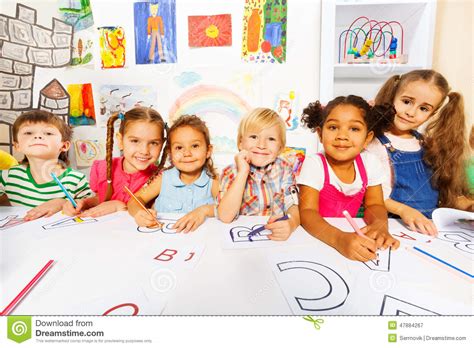 Group Of Kids Boys And Girls In Reading Class Stock Photo