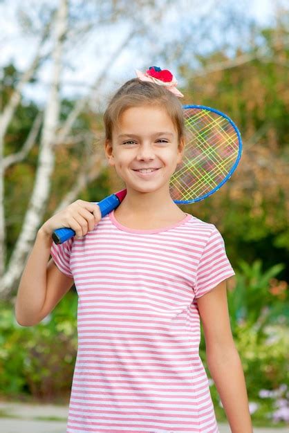 premium photo cute girl with racket outdoors