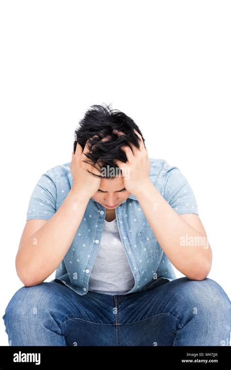 Frustrated Man Sitting With His Hands On Head Stock Photo Alamy