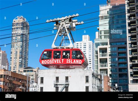 People Riding Roosevelt Island Red Gondola Of Aerial Tramway New York