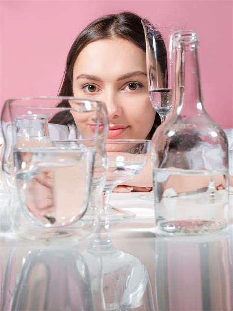 Portrait Of A Young Brunette In Refraction Through Glasses Of Water