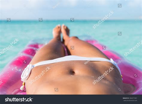 Sexy Bikini Body Abs Stomach Closeup And Tanned Legs Of Beach Woman