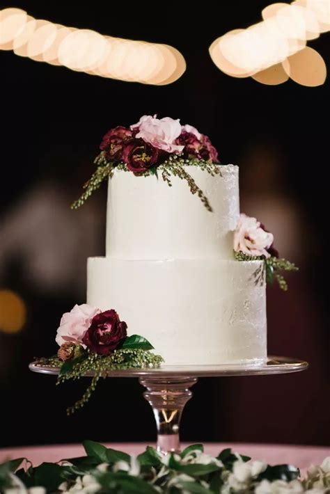 two tier cake with burgundy and blush flowers in 2020 burgundy wedding cake beautiful wedding