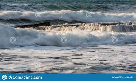 Rocky Seashore With Wavy Ocean And Waves Crashing On The Rocks Stock
