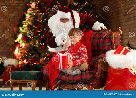Santa Claus And Little Boy With T Near Christmas Tree Stock Image