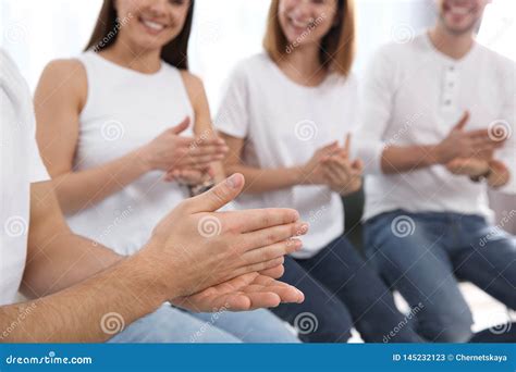 Group Of Young People Learning Sign Language With Teacher Indoors Stock
