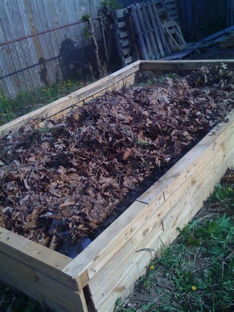 Raised Garden Bed Made From Recycled Pallets Filled With Logs Some