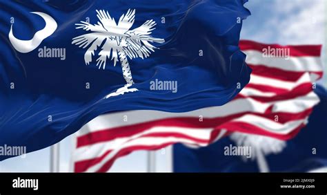 The South Carolina State Flag Waving Along With The National Flag Of