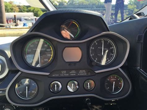 The Dashboard Of A Vehicle With Multiple Gauges On Its Face And Hands