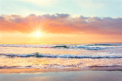 Ocean Wave On The Beach At Sunset Time Sun Rays Stock Photo Download