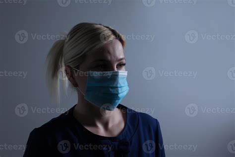 An Attractive Young Woman Wears A Paper Face Mask To Protect Herself