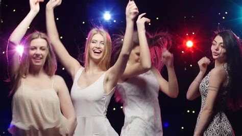 four girls dancing together and blowing kisses in a disco stock footage