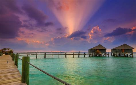 nature landscape sun rays beach clouds resort sunset bungalow walkway sea maldives