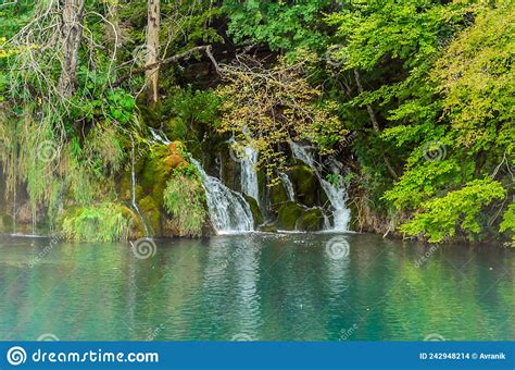 Waterfalls Over The Turquoise Waters Of The Mountain Lake In Plitvice