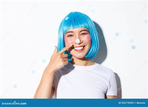 Image Of Cute And Silly Asian Girl With Confetti On Her Nose Smiling And Looking Happy Wearing