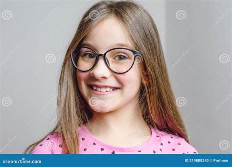 Portrait Of A Cute Beautiful 8 Year Old Girl With Glasses Stock Photo