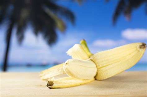 Fresh Yellow Banana With Palm Beach Behind Stock Photo Download Image