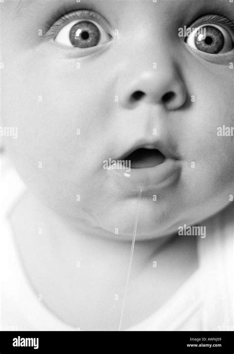 Baby With Mouth Open Drooling Eyes Wide Open Looking Out Of Frame Stock Photo Alamy