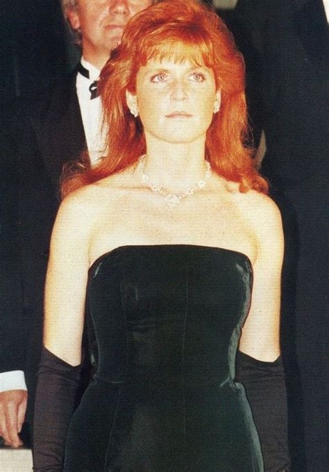 A Woman With Red Hair Wearing A Black Dress