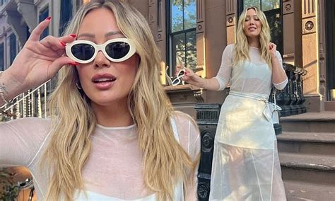 hilary duff flashes her toned legs and bra in edgy sheer white dress as she poses up in new york