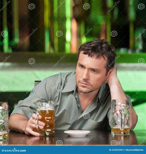 Relaxing At The Bar Portrait Of Depressed Young Men Drinking Be Stock