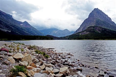 Clear Lake And High Mountains In Glacier National Park Stock Image