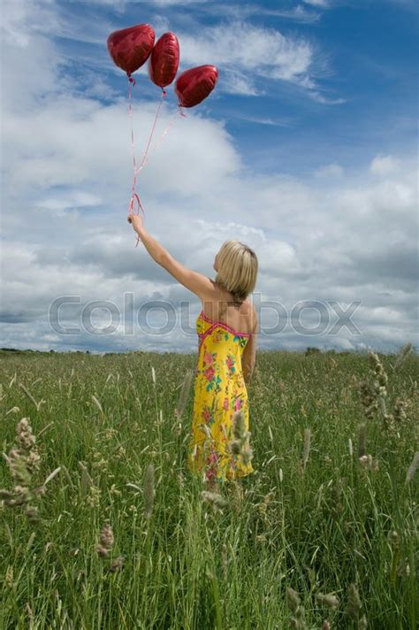 Woman Holding Balloons In Field Stock Image Colourbox