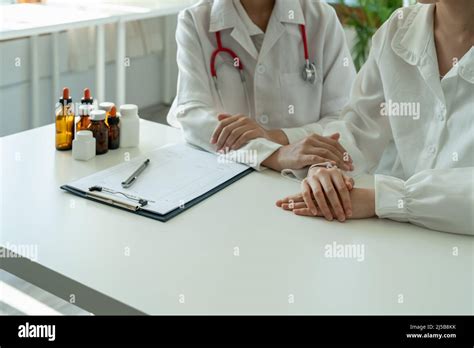 Asian Female Doctor In White Medical Uniform Consult Female Patient In