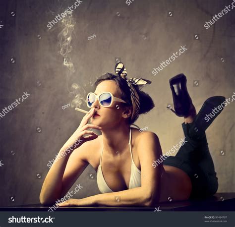 Beautiful Woman Smoking A Cigarette Stock Photo 91464707