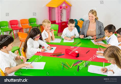 Friendly Female Teacher Talking Children Sitting Stock Photo 1479534404