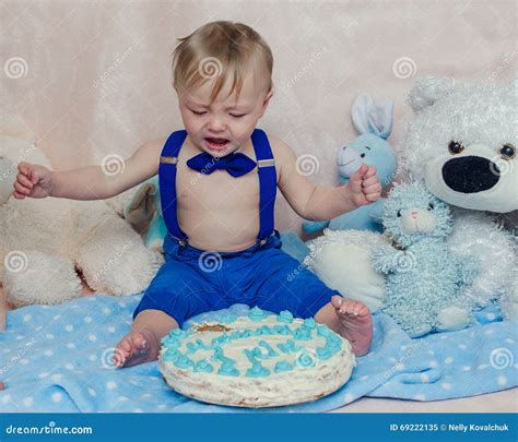 Baby Boy Crying While Eating His Birthday Party Cake Stock Image